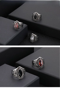 Macro detail of vintage steel rings with red ruby stones and floral engravings
