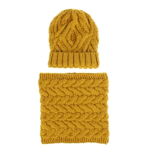 Detailed cable knit texture of the yellow winter beanie hat and matching neck warmer scarf