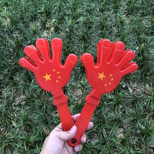 Détails de mains de supporters rouges en plastique avec étoiles jaunes pour célébrations
