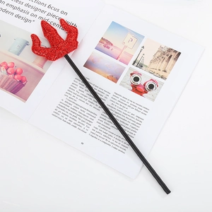 Halloween devil trident prop with red sequins and black handle on a modern magazine