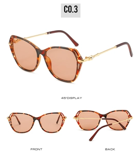 Vue détaillée des lunettes de soleil en écaille avec verres orange et branches dorées