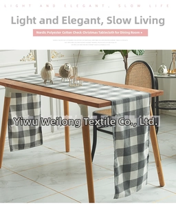 Detail of gray and white checkered table runner on a wooden dining table in Nordic style