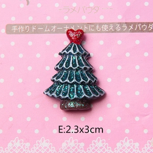 Macro shot of 3cm resin Christmas tree with glitter finish and a red heart top ornament