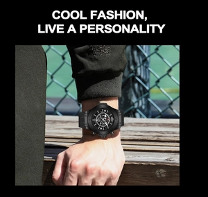 Close-up of black men's sports watch with silicone strap and calendar on male wrist