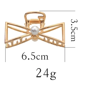 Detailed view of golden butterfly hair claw with pearl inlay and exact dimensions