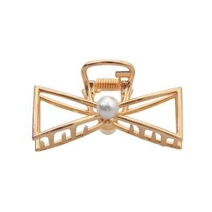 Minimalist gold metal hair claw clip with pearls and geometric triangle design on white back