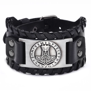 Macro detail of black braided leather cuff featuring a silver Viking hammer metal plate