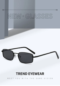 Detail view of small rectangular metal sunglasses with black lenses and slim frame