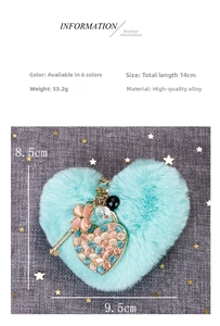 Macro view showing dimensions of teal heart pom pom keychain with gold alloy hardware