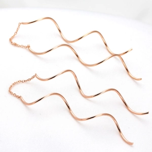 Elegant rose gold S-shaped wavy drop earrings featuring a long tassel threader design