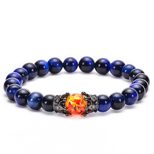 Detailed view of 10mm blue tiger eye beads and crown charm on elastic stone bracelet
