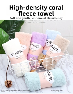 Close-up of soft thick coral fleece towels in multiple pastel colors neatly folded