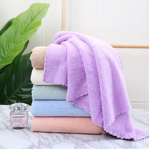 Close-up of stacked colorful coral fleece towels in purple pink and blue tones