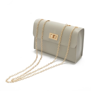 Light gray PU leather phone bag with gold twist lock and chain strap on white background