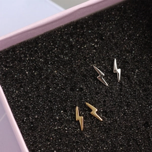 Macro detail of lightning bolt silver studs in gold and silver finish on display