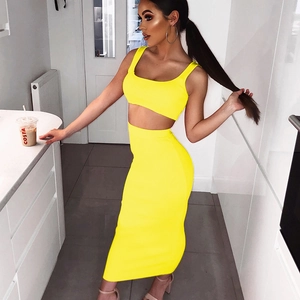 Detail of yellow ribbed knit two-piece set featuring cropped camisole and high-waist skirt