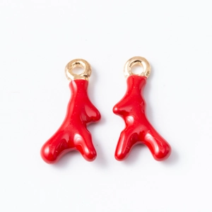 Pair of red coral branch pendant charms with gold-plated rings on white background