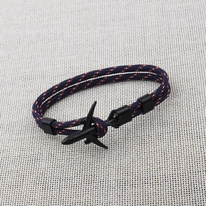 Close-up of navy blue 550 paracord bracelet with a black metal airplane buckle fastener