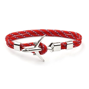 Detail of red braided polyester rope bracelet with silver airplane metal buckle closure