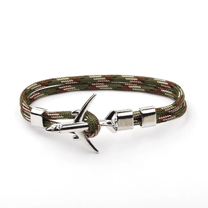 Detailed view of camouflage braided cord bracelet with silver airplane metal fastener