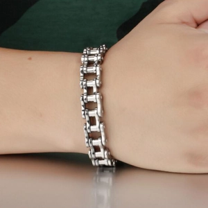 Close-up of a 12mm silver stainless steel bicycle chain bracelet on a woman's wrist