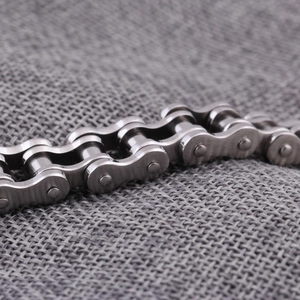 Macro detail of 12mm stainless steel bicycle chain bracelet with polished metallic finish