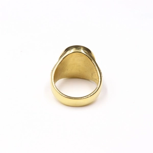 Macro side view of gold-tone praying hands ring with skeleton skull signet design