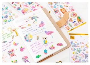 Detail of bronzing crystal epoxy stickers with flamingo and star patterns for DIY journals
