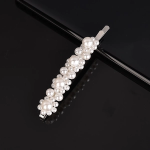 Detail shot of elegant floral pearl hair clip with white beads on metal base