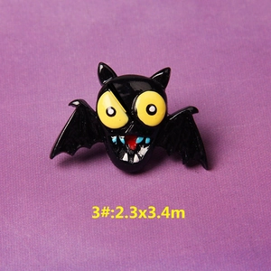 Detail of cartoon Halloween bat brooch with yellow eyes and vibrant enamel finish