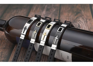 Detail of adjustable black silicone wristbands with gold and silver cross metal plates