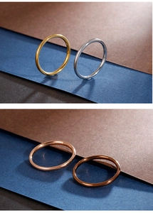 Detailed view of four minimalist ultra-slim polished stackable rings in various metallic tones