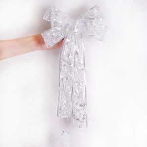 Detail of silver sequined Christmas bow with LED lights and battery box for decoration