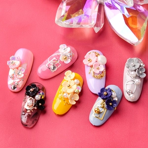 Mix of 3D shell flower nail charms with pearls and rhinestones on colorful press-on nails
