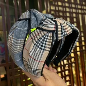 Classic checkered knotted wide headbands in blue and beige with black trim detail
