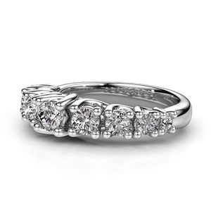 Macro shot of silver anniversary band with claw-set gradient round-cut zircons on white backdrop