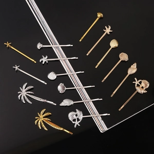 Detailed view of ocean-themed gold and silver hair clips featuring starfish and shells