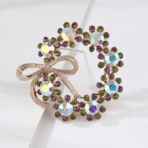 Macro shot of luxury wreath brooch with purple crystals and rainbow rhinestones