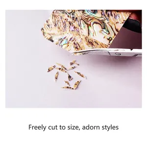 3D Iridescent natural shell thin sheets for nail art decoration being cut to custom size