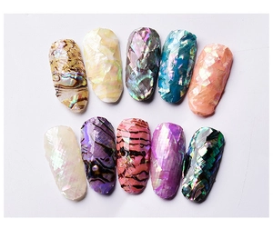 Macro detail of 10 multicolor natural shell texture 3D nail art stickers in diamond cut
