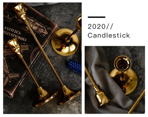 Close-up of elegant gold metal candlesticks with trumpet base and mirror finish