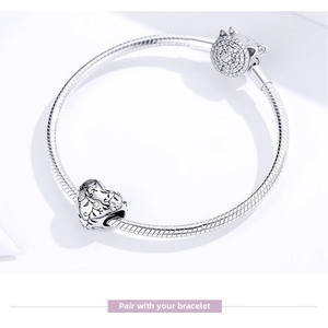 Close-up of S925 silver snake chain bracelet with filigree heart charm and pavé clasp