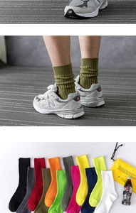 Detail of ribbed knit cotton socks in 12 vibrant colors featuring olive green crew style