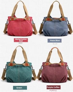 Multiple colors of large canvas shoulder bags including red, blue, green and purple