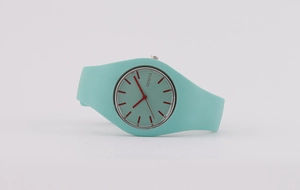 Detail view of the light blue silicone strap and silver bezel on the Geneva quartz watch