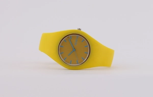 Close-up of Geneva silicone watch with yellow strap, tan dial and blue hands detail