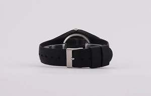 Detailed side view of black silicone watch strap with a polished silver metal buckle