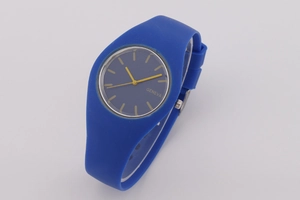 Detail shot of navy blue Geneva watch face with vibrant yellow hands and silicone strap