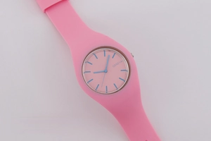 Pink Geneva silicone watch featuring a minimalist round dial with blue hands and markers