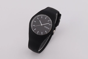 Close-up of black Geneva quartz watch dial with silicone strap and minimalist design